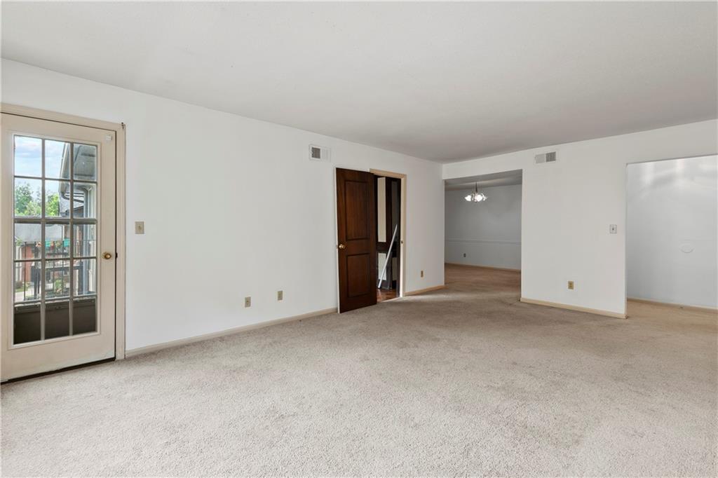 Spare room featuring light colored carpet