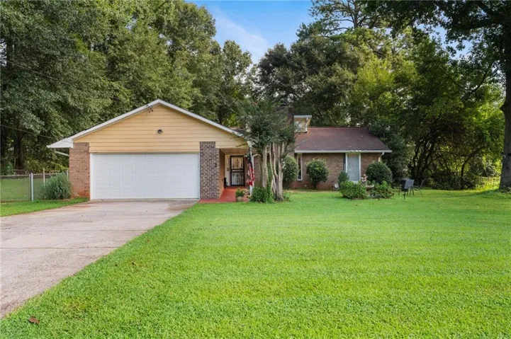 Brick and siding exterior with an attached garage