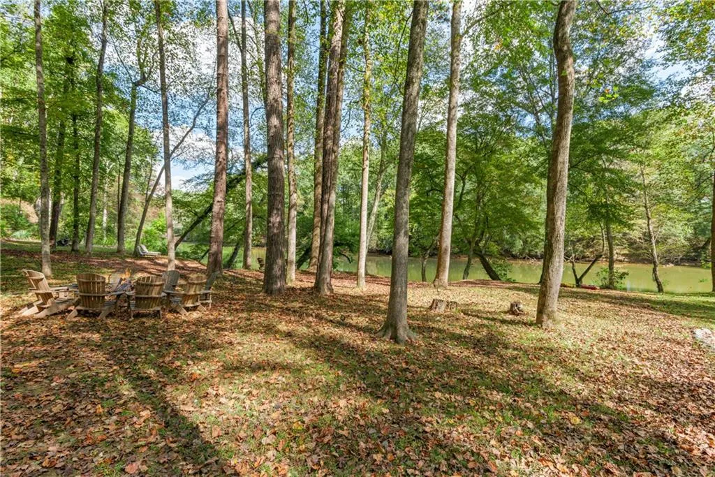 Large Flat Backyard by the River.  The light colored lounge chairs top left are on the property