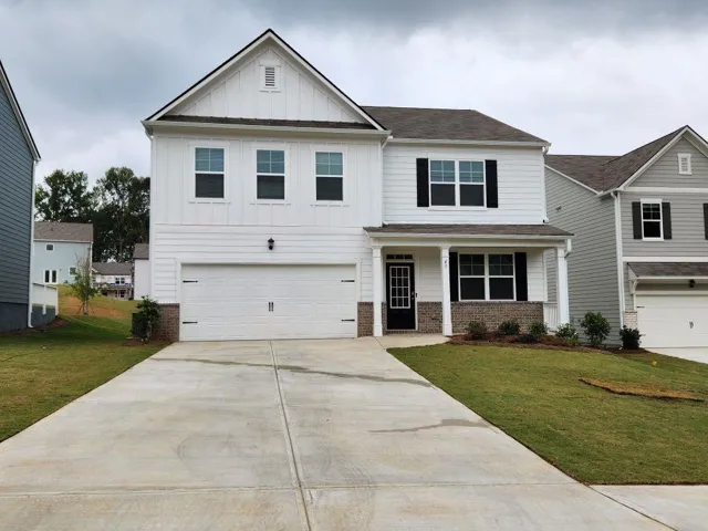 Two-story colonial with white fiber cement siding and a two-car garage featuring white panel doors