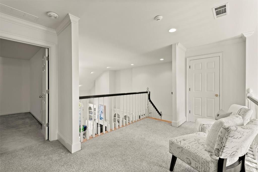 The landing overlooks the living room on one side and the foyer on the other. The landing overlooks the living room on one side and the foyer on the other.