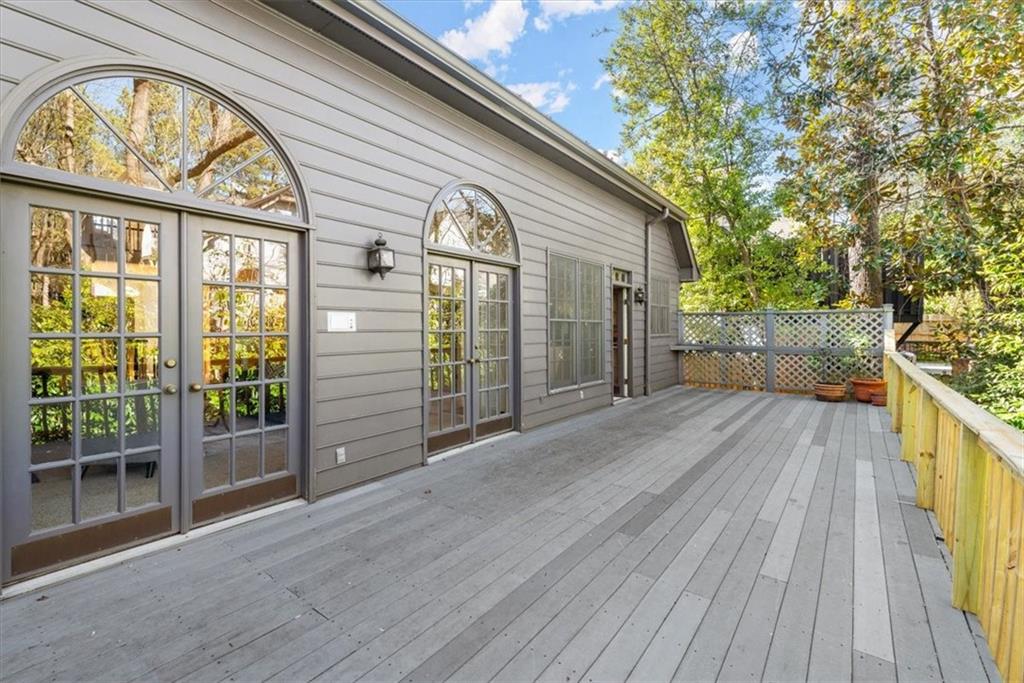 Embrace the tranquility of nature as the living room's double doors effortlessly open onto the expansive back deck. Surrounded by tall trees, this retreat-like oasis offers a serene escape right at your doorstep. With an additional door from the kitchen, the large deck becomes the perfect setting for al fresco dining and relaxation, seamlessly blending the boundaries between indoor and outdoor living. Embrace the tranquility of nature as the living room's double doors effortlessly open onto the expansive back deck. Surrounded by tall trees, this retreat-like oasis offers a serene escape right at your doorstep. With an additional door from the kitchen, the large deck becomes the perfect setting for al fresco dining and relaxation, seamlessly blending the boundaries between indoor and outdoor living.