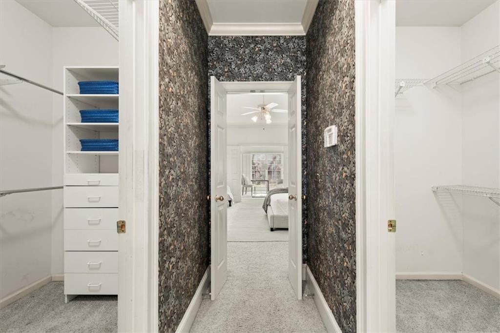 The primary suite offers the convenience of separate his and hers walk-in closets, connected by a hallway that seamlessly links the primary bedroom to the primary bathroom. Embrace the luxury of abundant storage space, allowing for organization and easy access to your wardrobe. The primary suite offers the convenience of separate his and hers walk-in closets, connected by a hallway that seamlessly links the primary bedroom to the primary bathroom. Embrace the luxury of abundant storage space, allowing for organization and easy access to your wardrobe.