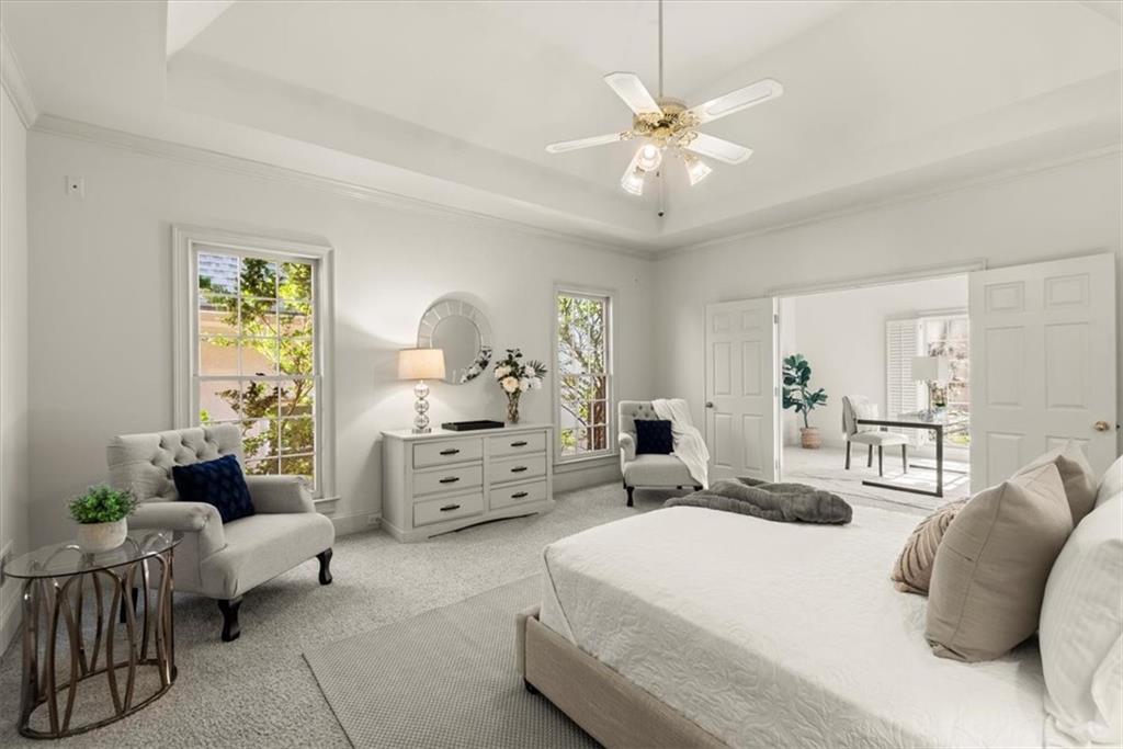 Enter the primary bedroom through a separate room accessed through double doors, flooded with natural light. This sun-drenched space is perfect for creating a home office or a cozy sitting room. Enter the primary bedroom through a separate room accessed through double doors, flooded with natural light. This sun-drenched space is perfect for creating a home office or a cozy sitting room.