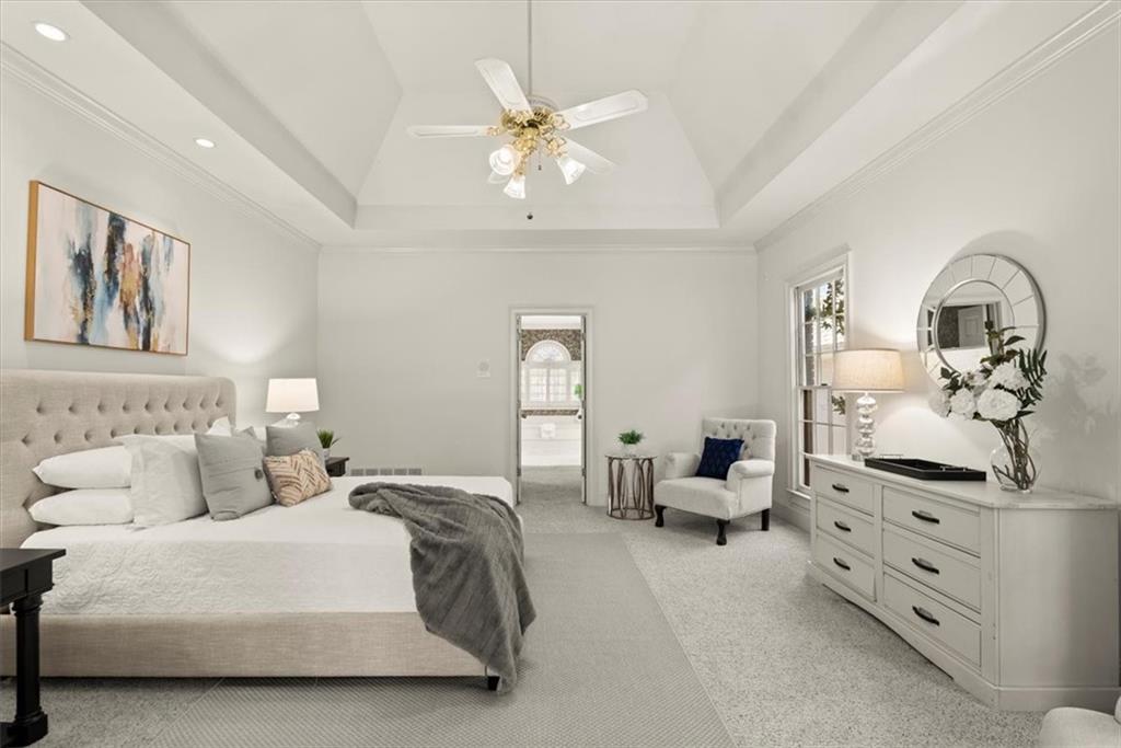 Discover a generously sized primary suite on the main floor that offers ample space for relaxation and rejuvenation. With high vaulted ceilings adding an open and airy feel, this room provides a peaceful sanctuary from daily life. Discover a generously sized primary suite on the main floor that offers ample space for relaxation and rejuvenation. With high vaulted ceilings adding an open and airy feel, this room provides a peaceful sanctuary from daily life.