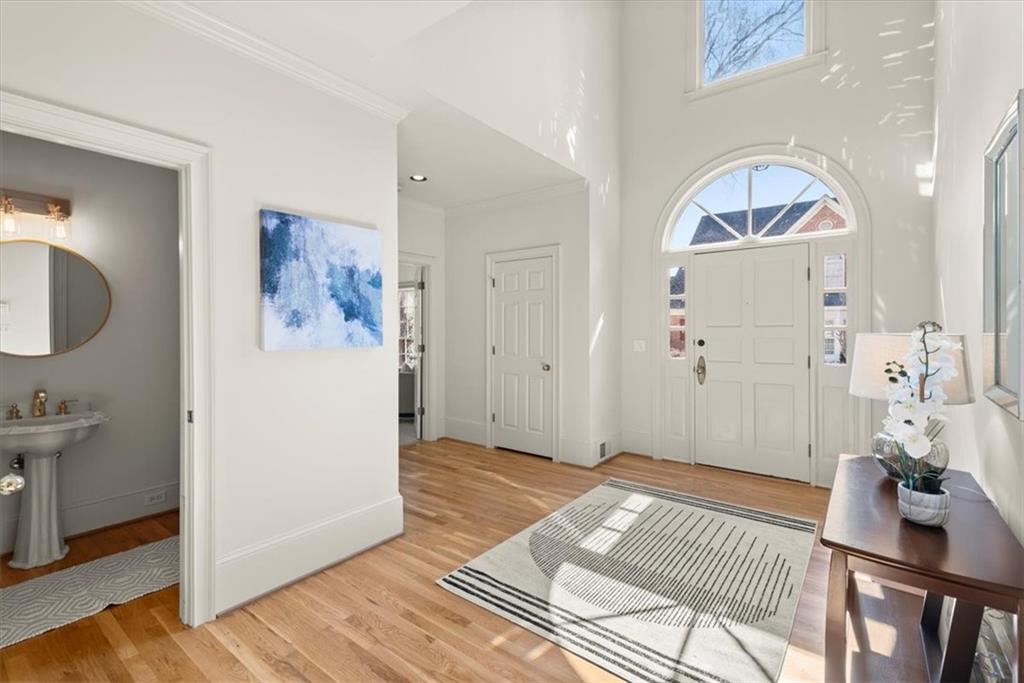 The open two-story foyer flooded with an abundance of natural light, creates a bright and inviting atmosphere. The open two-story foyer flooded with an abundance of natural light, creates a bright and inviting atmosphere.