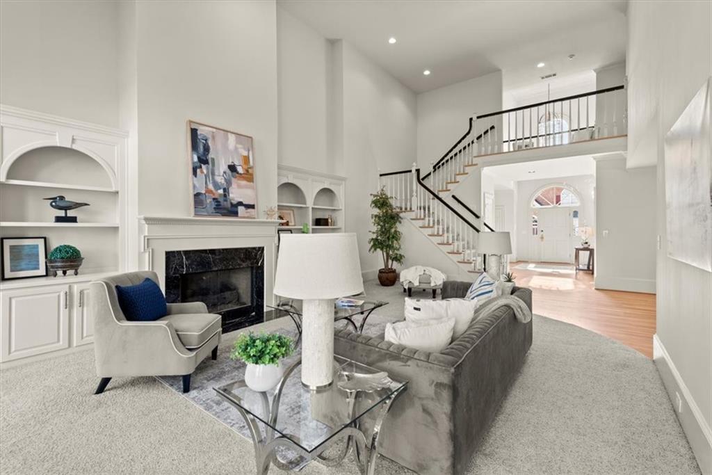 Discover your living room featuring built-in bookcases and a charming fireplace. Discover your living room featuring built-in bookcases and a charming fireplace.