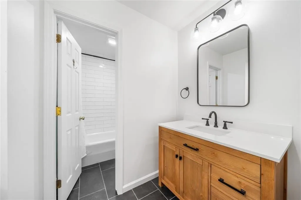 Second bathroom with separate shower and commode.