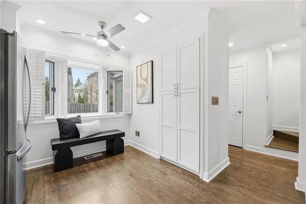Sitting room with dark wood-style floors, crown molding, a ceiling fan, and recessed lighting
