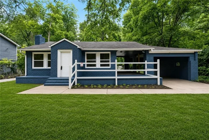 Blue brick exterior with white trim windows and door