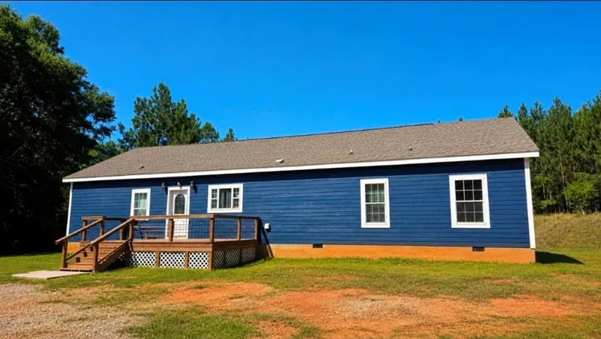 Exterior featuring a blue siding facade, white trim, and a gray shingle roof