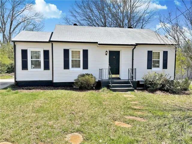 White siding exterior with black shutters and trim