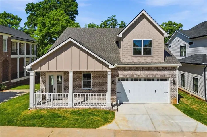 the back of the home showcases a spacious covered porch designed for confortable outdoor living.