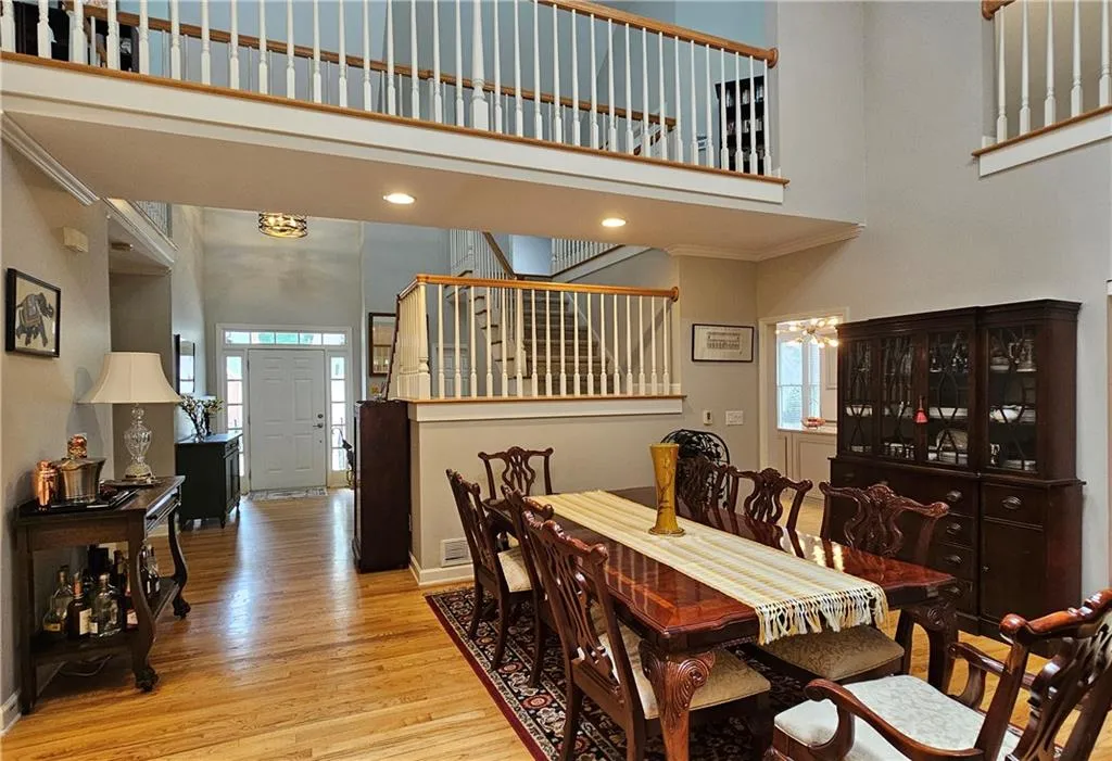 Living area with light wood-type flooring, high vaulted ceiling, ceiling fan, a fireplace, and recessed lighting