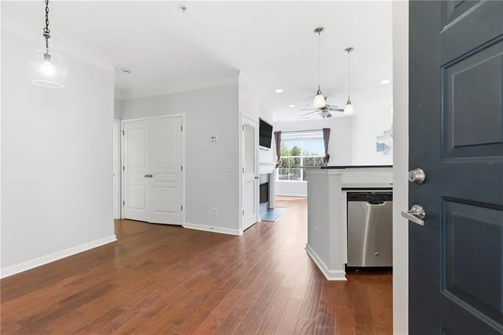 Entryway featuring dark wood finished floors, ceiling fan, ornamental molding, and recessed lighting