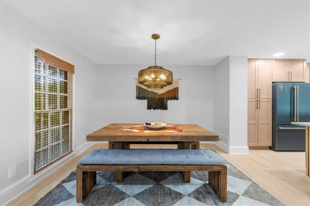 Dining room featuring light wood-type flooring and baseboards
