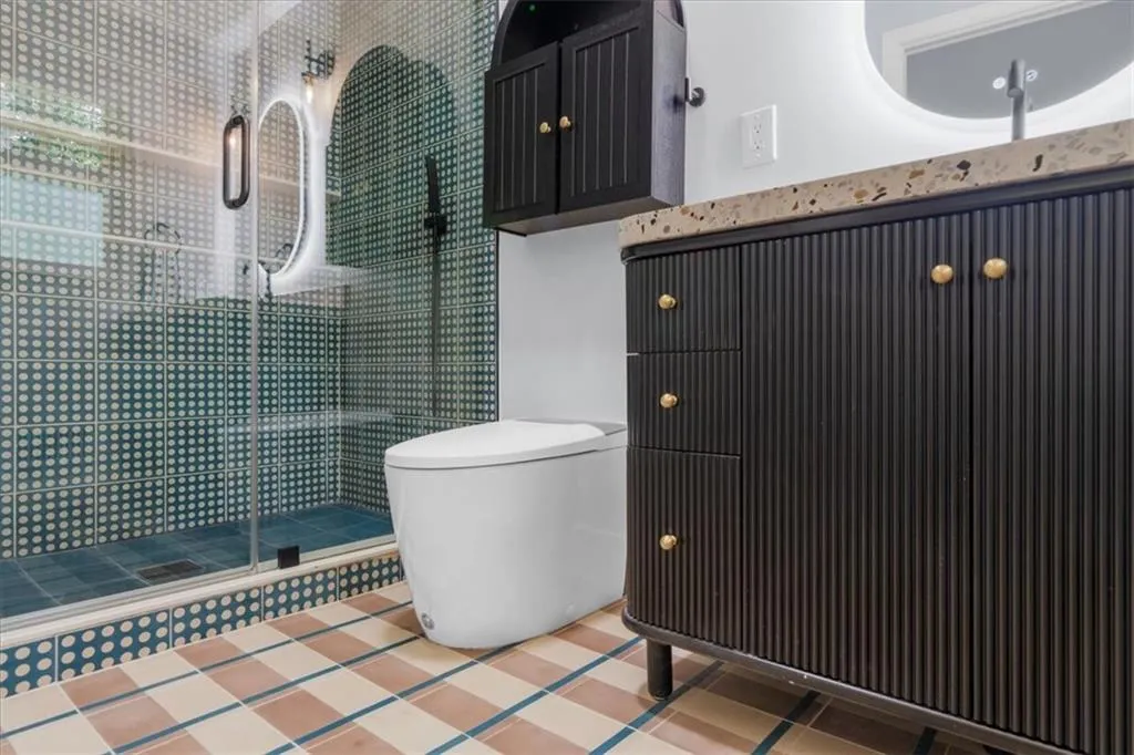 Bathroom with a shower stall and vanity