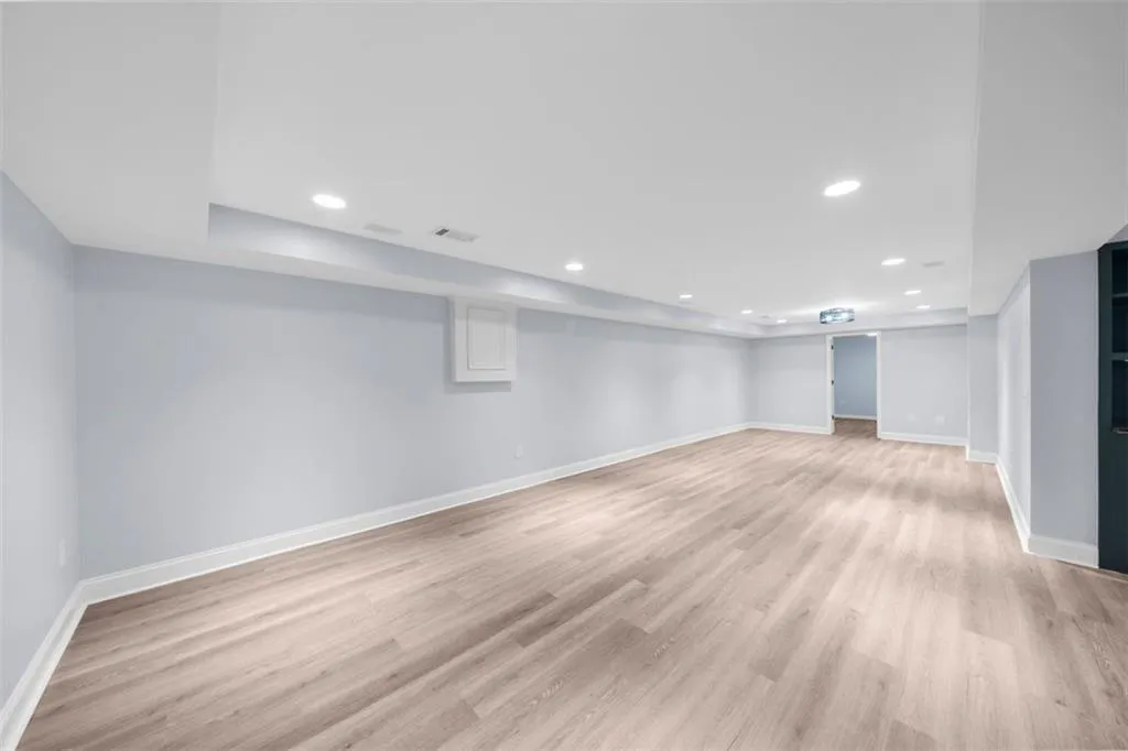 Finished basement featuring recessed lighting and light wood finished floors