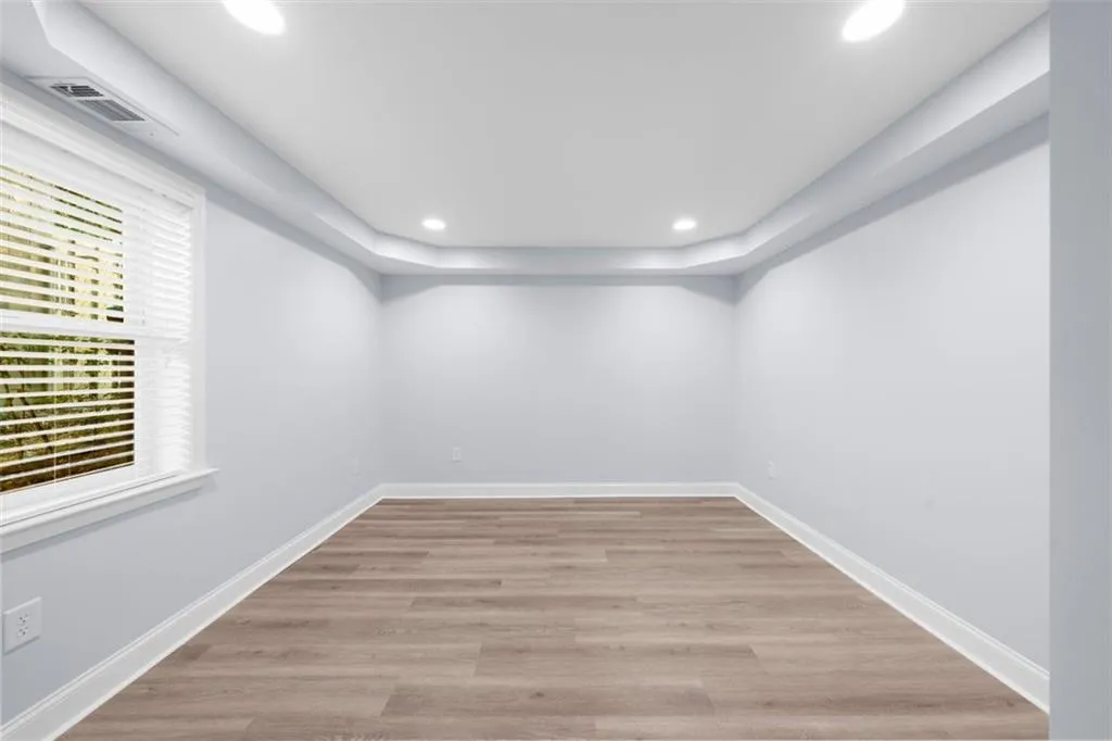 Spare room featuring light wood finished floors and recessed lighting
