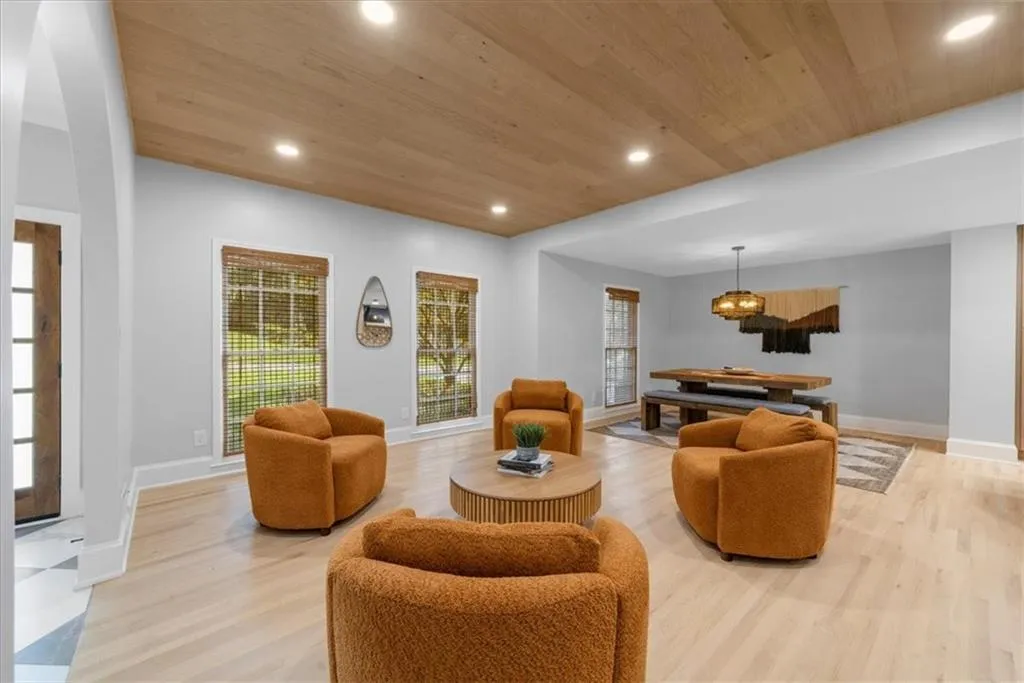 Living room with recessed lighting, wood ceiling, and light wood-style flooring