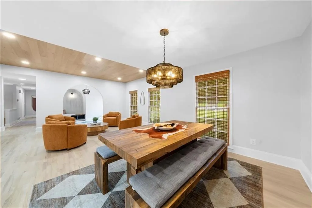Dining room with recessed lighting, light wood-style flooring, a chandelier, and wooden ceiling
