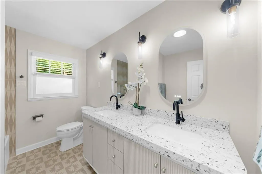 Bathroom with double vanity and toilet