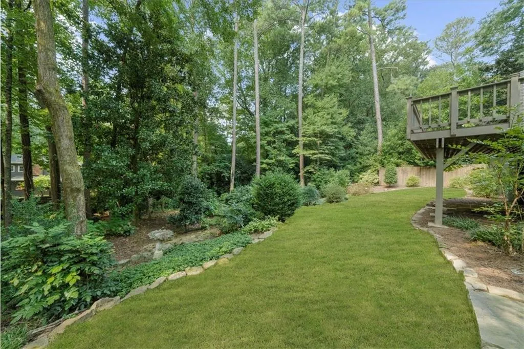 View of green lawn with a deck