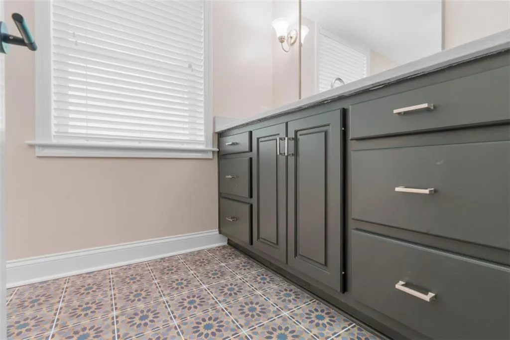 Bathroom featuring light tile patterned flooring and plenty of natural light