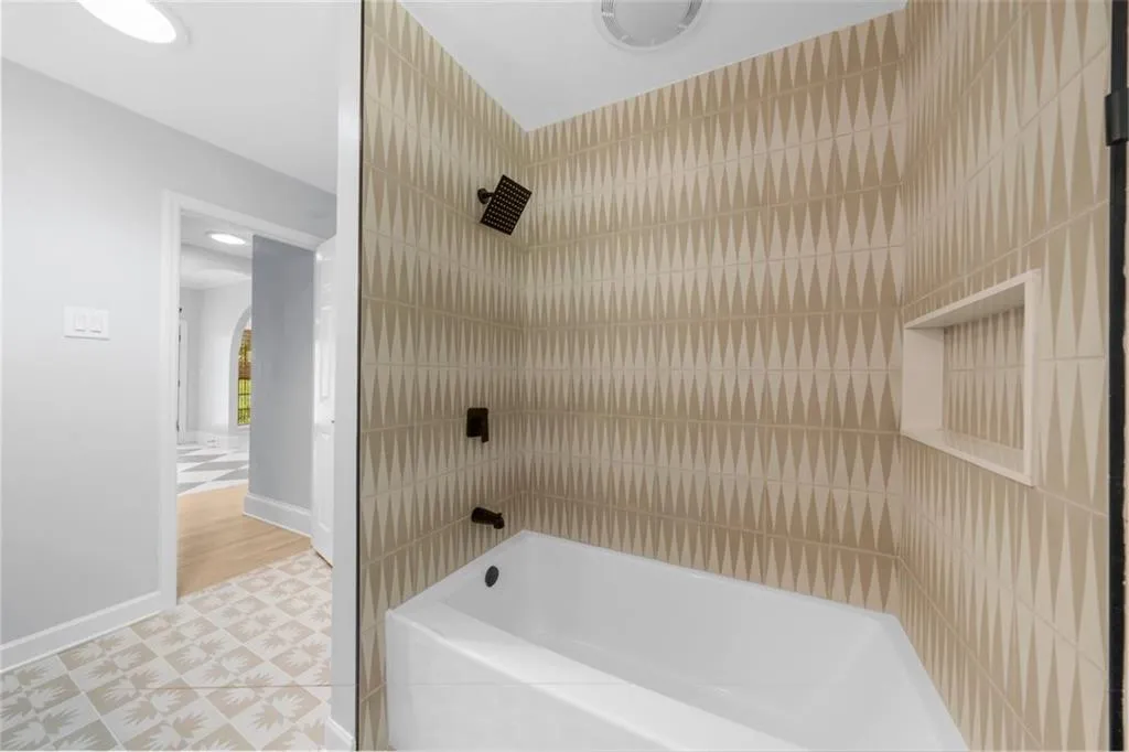 Bathroom featuring shower / bath combination and light tile patterned floors