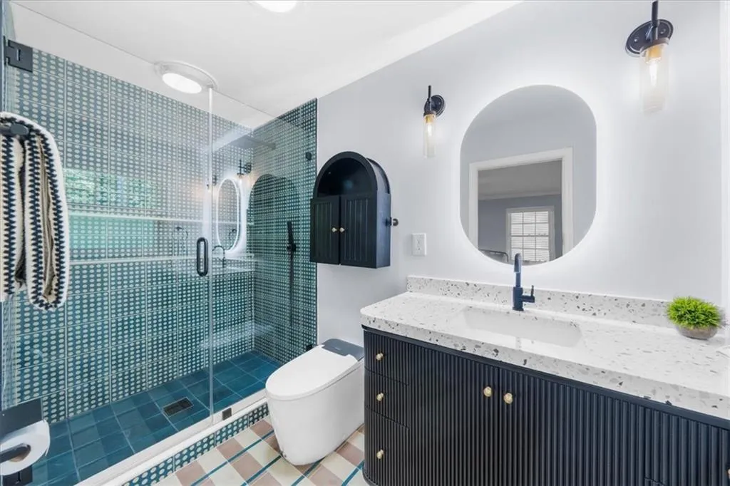 Bathroom featuring vanity and a stall shower