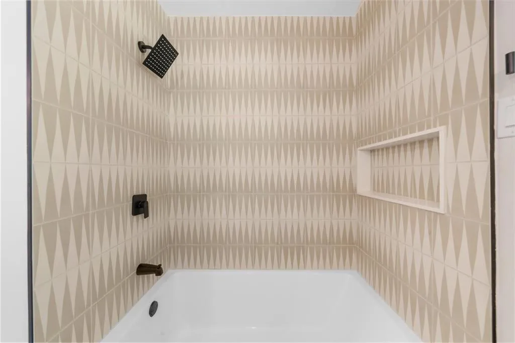Full bath featuring shower / tub combination