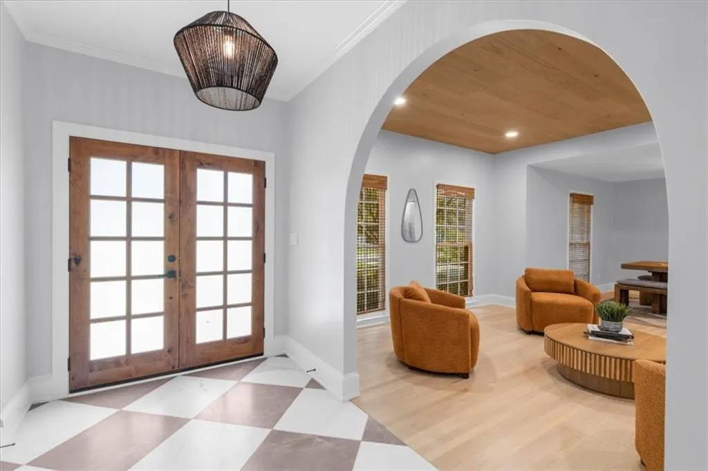 Entryway with recessed lighting, french doors, healthy amount of natural light, arched walkways, and wood ceiling