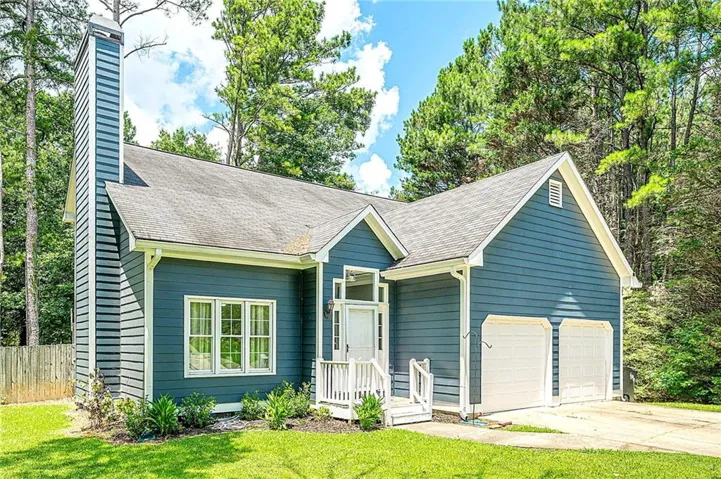 Blue siding exterior with a prominent tall chimney