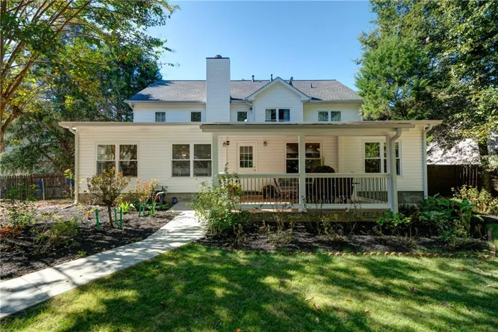 Rear view of property featuring a lawn