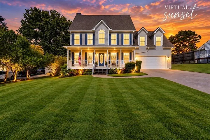 Two-story residence with a covered front porch, an attached garage, and a wide driveway