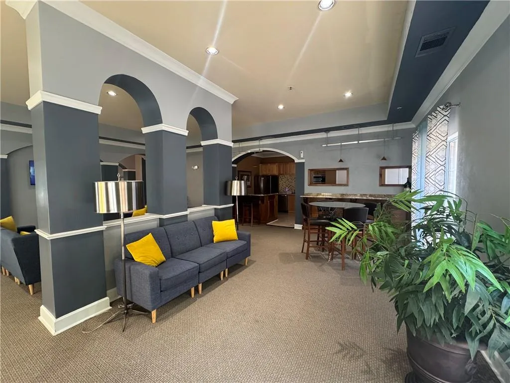 Community lobby with ornamental molding and recessed lighting