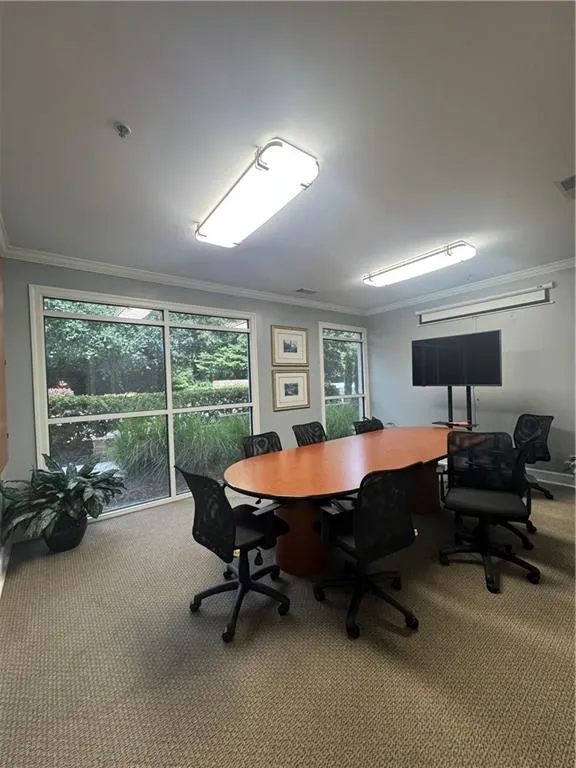 Carpeted home office featuring ornamental molding