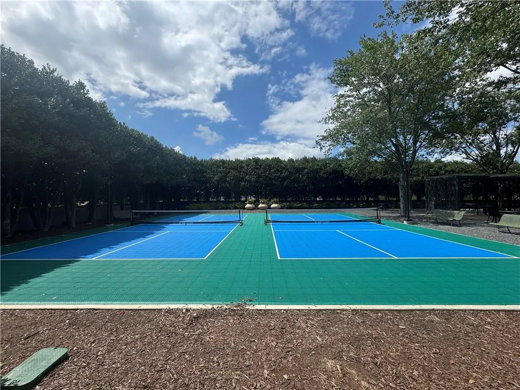 View of tennis court with community basketball court