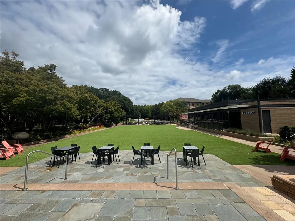 View of property's community featuring a yard and a patio area