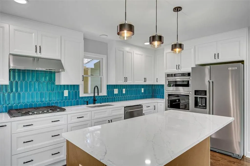 Stunning kitchen features all-new high-end appliances, elegant finishes, and a large island that provides abundant workspace and a perfect spot for casual dining or entertaining. Stunning kitchen features all-new high-end appliances, elegant finishes, and a large island that provides abundant workspace and a perfect spot for casual dining or entertaining.