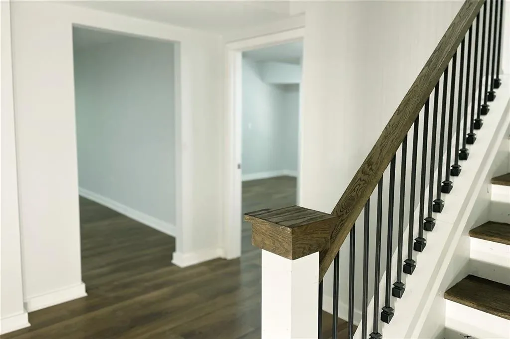 Staircase featuring baseboards and wood finished floors Staircase featuring baseboards and wood finished floors