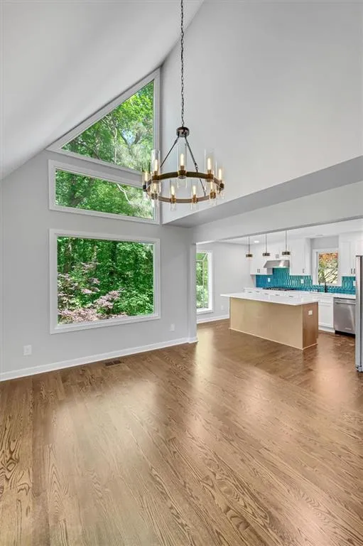 Dining room featuring high vaulted ceiling, a chandelier. Dining room featuring high vaulted ceiling, a chandelier.
