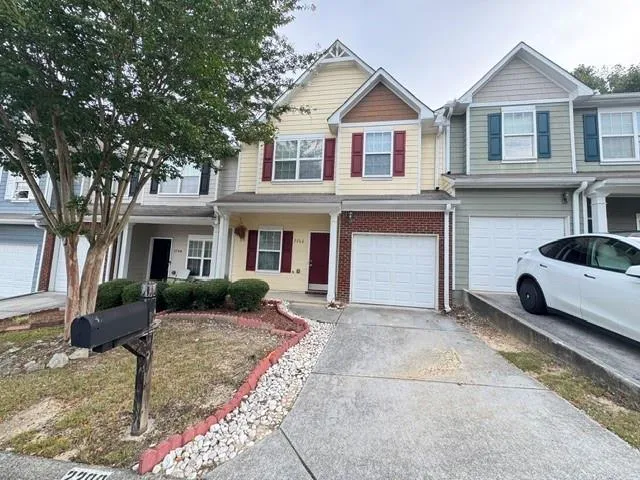 Two-story residence featuring a combination of brick and siding, an integrated single-car garage, and a concrete driveway