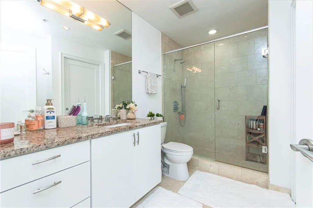 Full bath with vanity, a stall shower, recessed lighting, and light tile patterned flooring