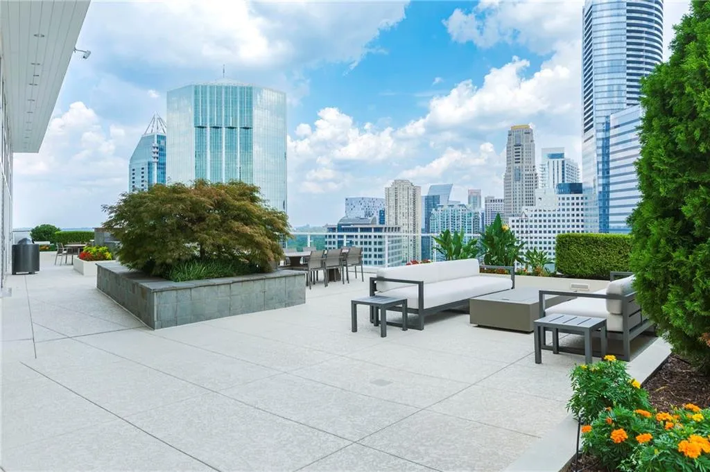 View of property's community with a patio area, a skyline view, and an outdoor hangout area