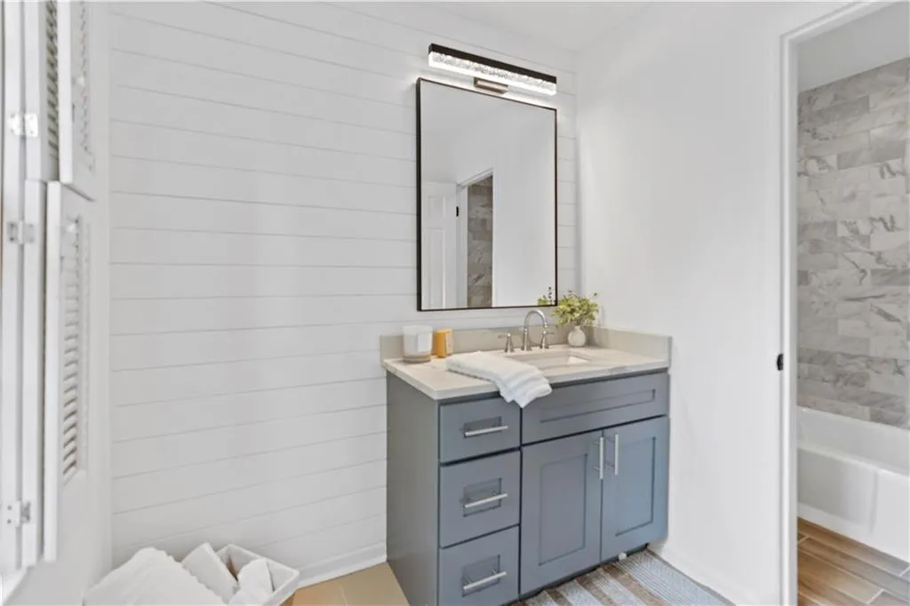 Ensuite Bathroom with vanity and wooden walls