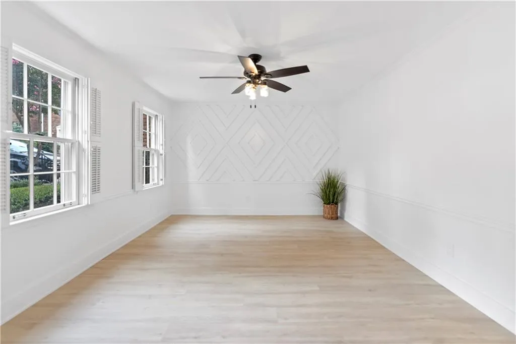 Unfurnished room with a ceiling fan and light wood finished floors