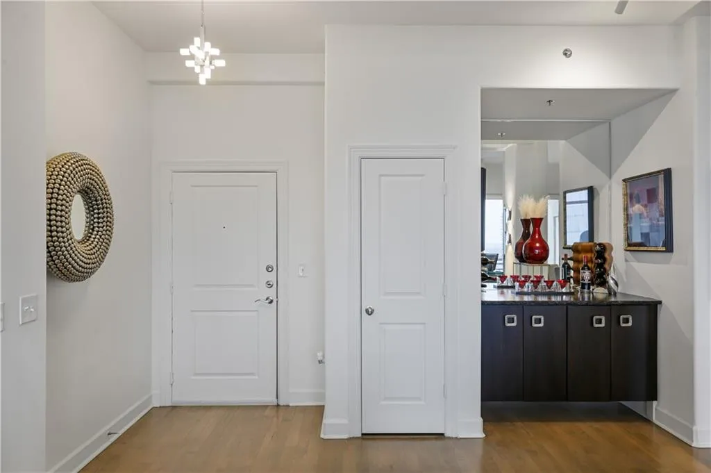 Entrance foyer featuring hardwood / wood-style floors and a chandelier