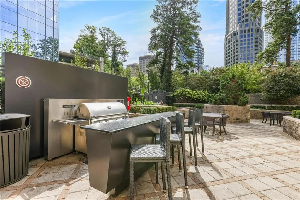 View of patio featuring an outdoor kitchen and a city view