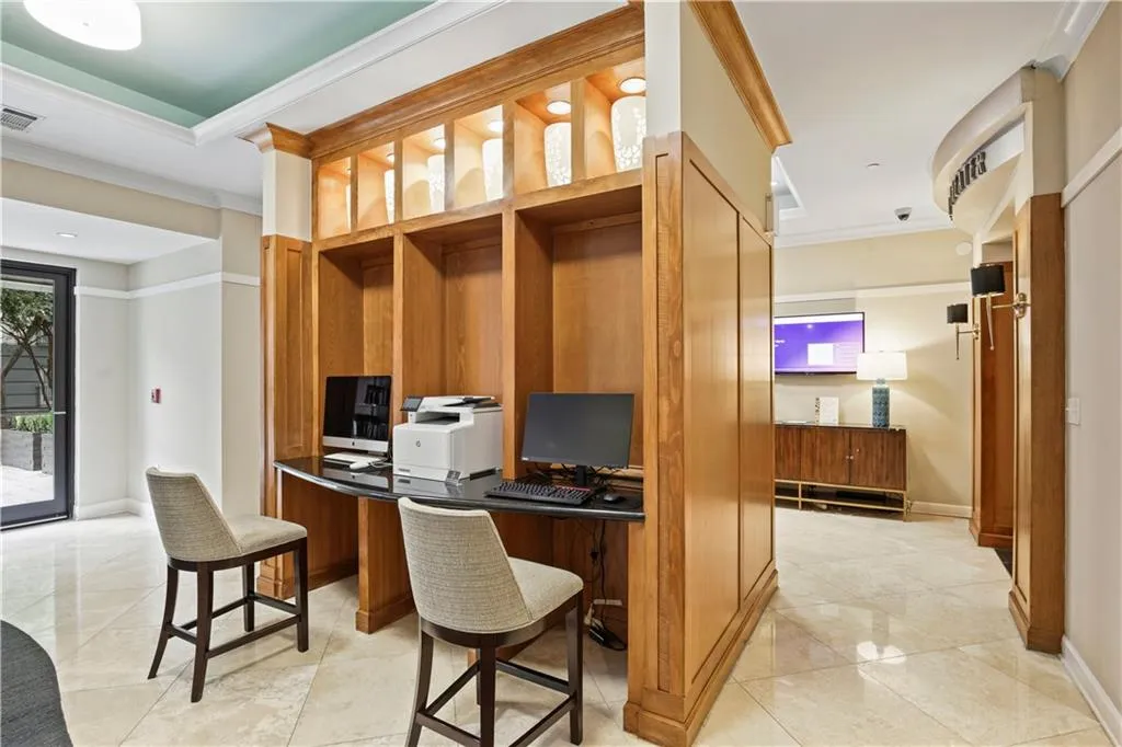 Tiled office featuring crown molding and built in desk